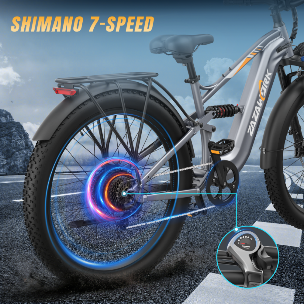 Szary rower elektryczny z 7-biegową przerzutką Shimano, świecącym silnikiem i wyświetlaczem biegów.