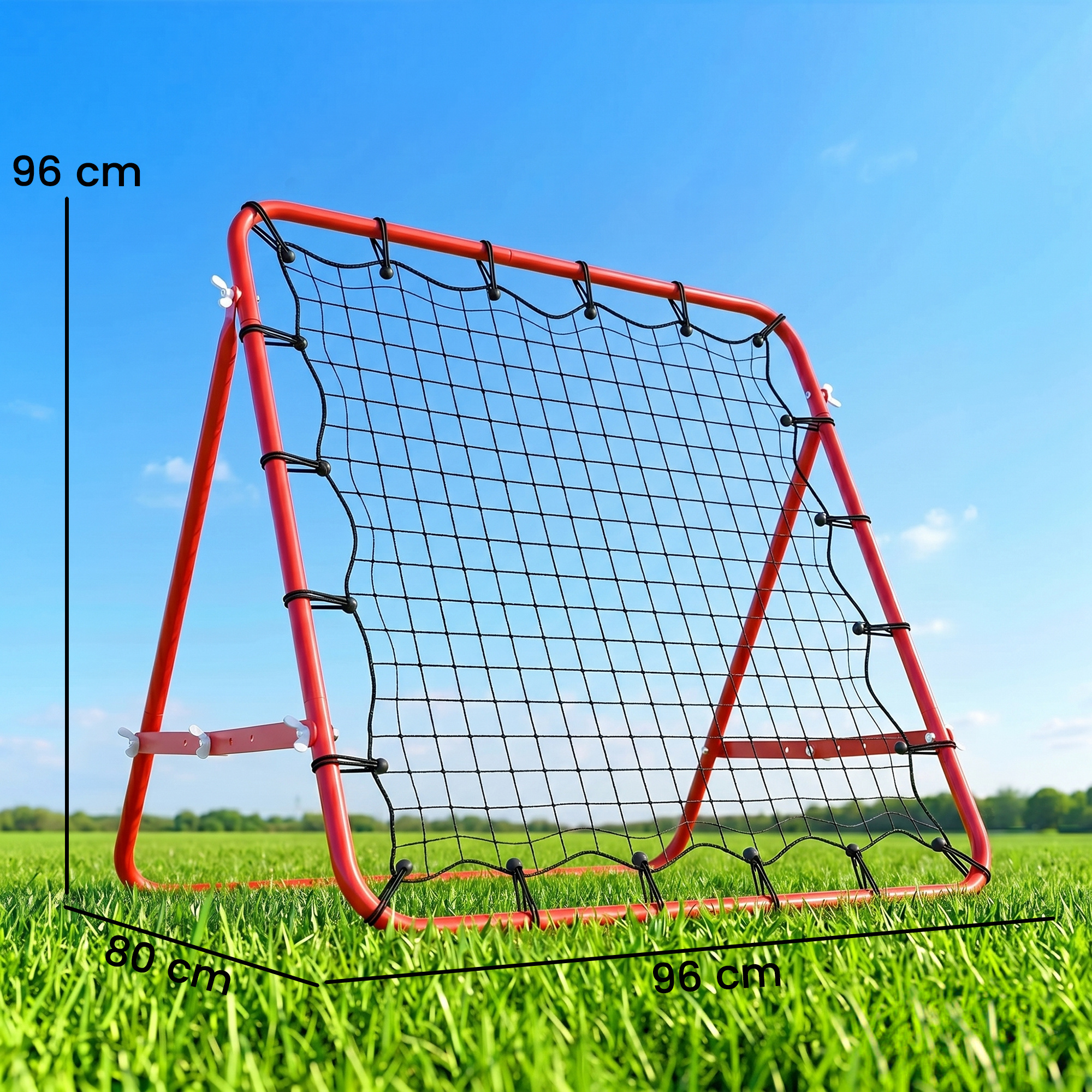 Una portería de rebote de fútbol roja con red se alza sobre un campo verde.