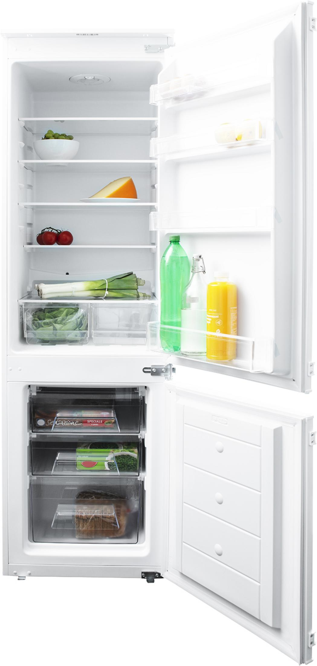 An open white refrigerator stocked with grapes, cheese, vegetables, drinks, and frozen food.