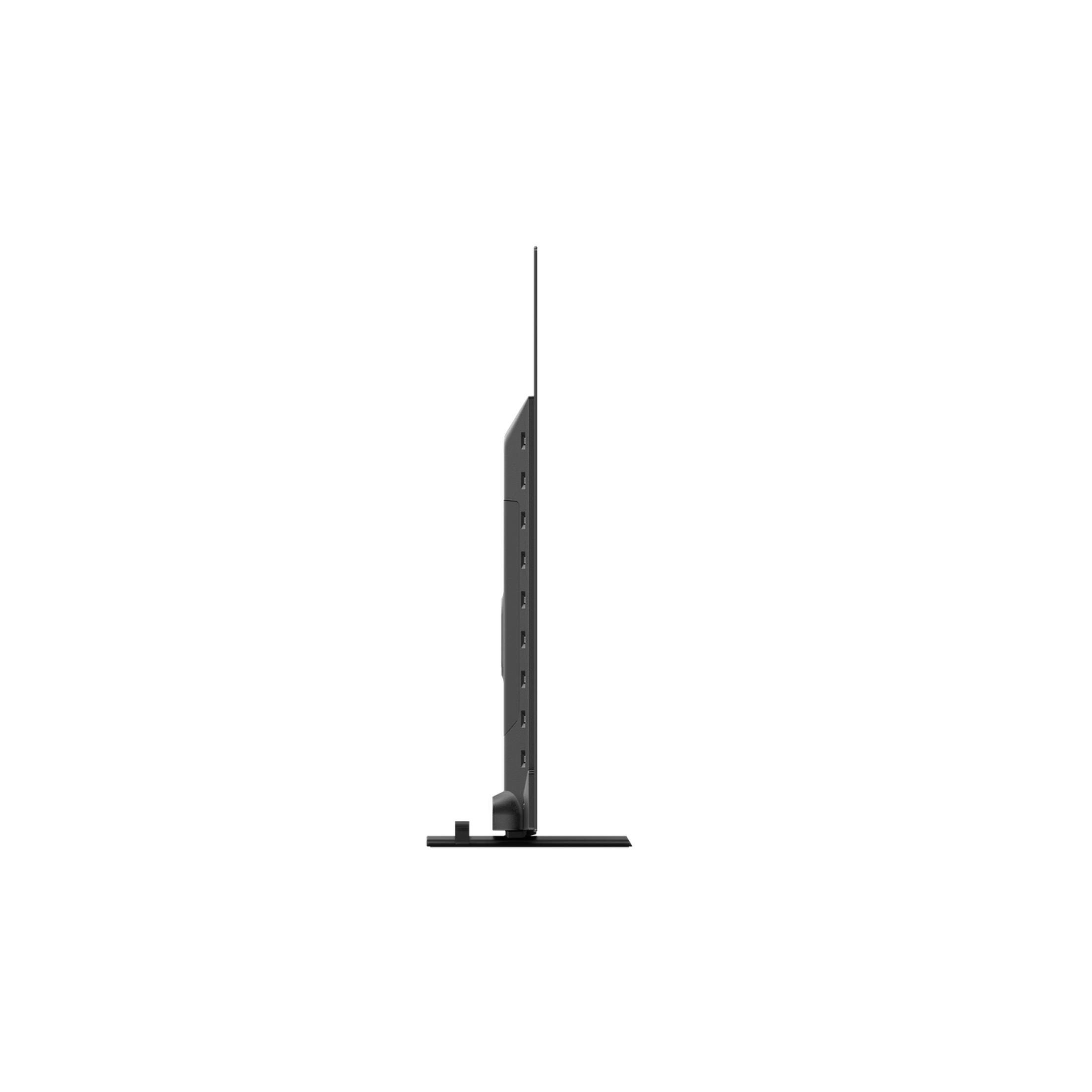 Téléviseur noir à bords fins sur un pied, vu de côté.