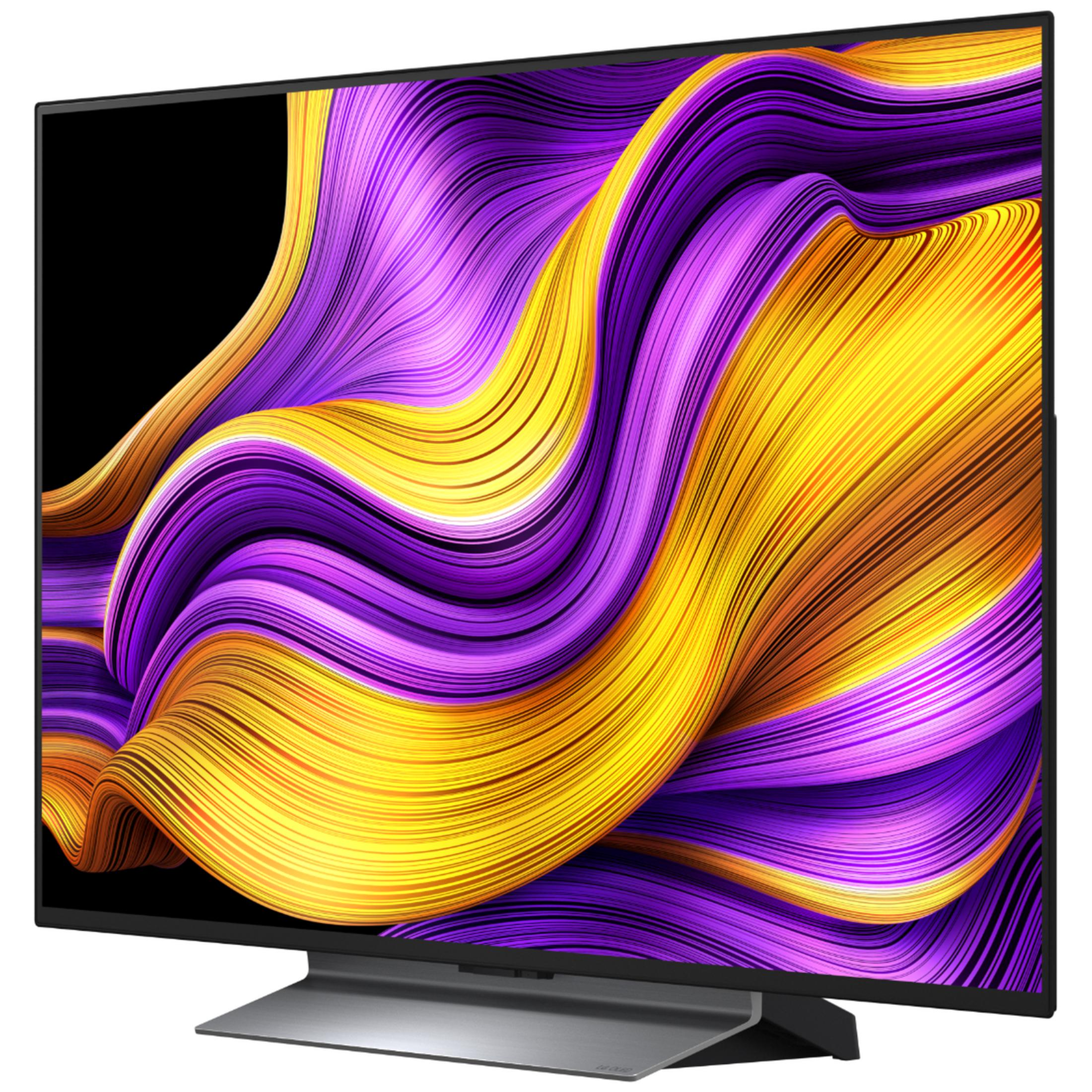 Nowoczesny telewizor wyświetlający abstrakcyjny, falujący wzór w kolorach fioletowym i żółtym.