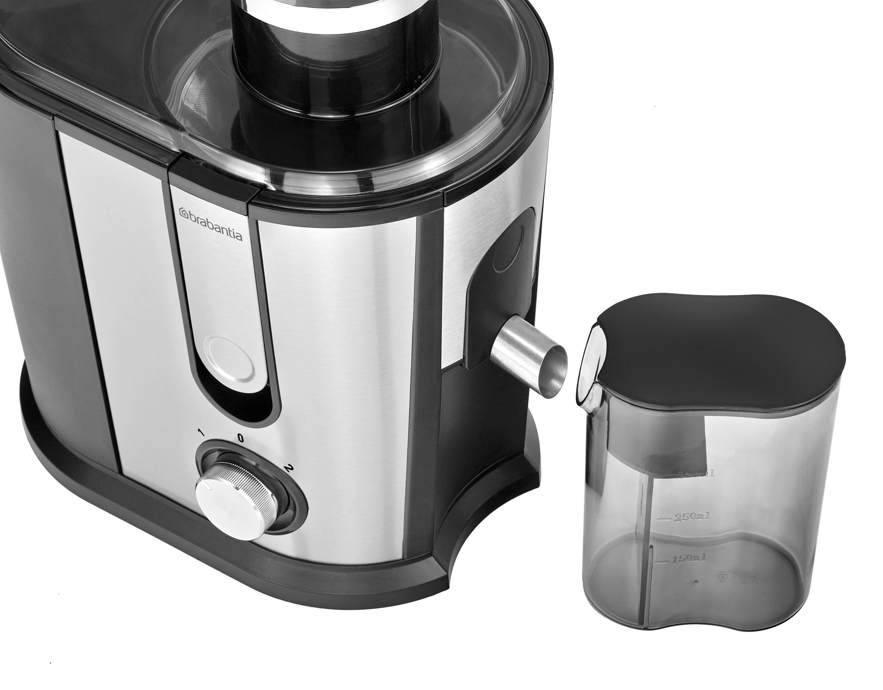 A silver juicer with a black lid and a separate collection jug.
