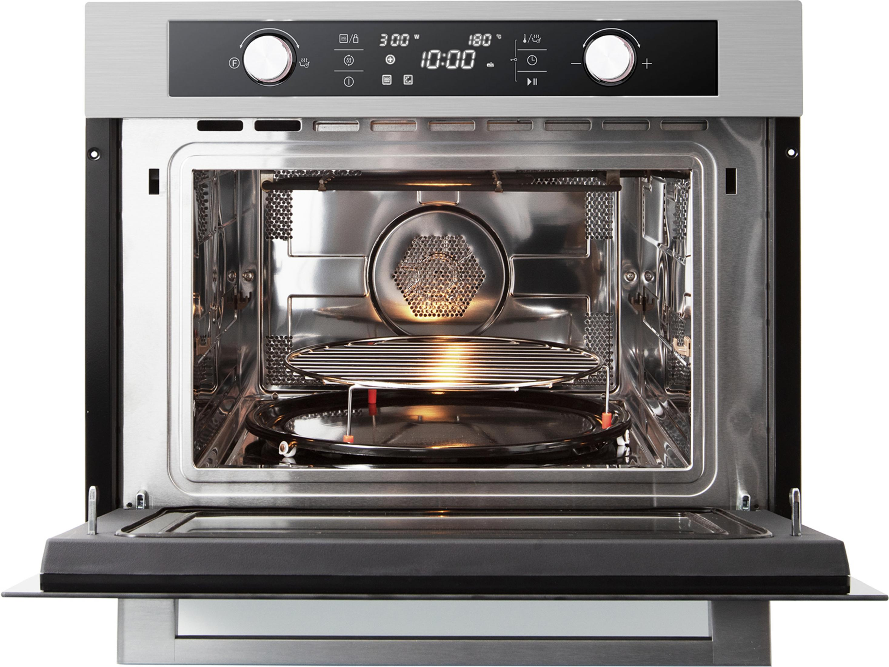 Open stainless steel microwave oven with illuminated interior, turntable and wire rack.