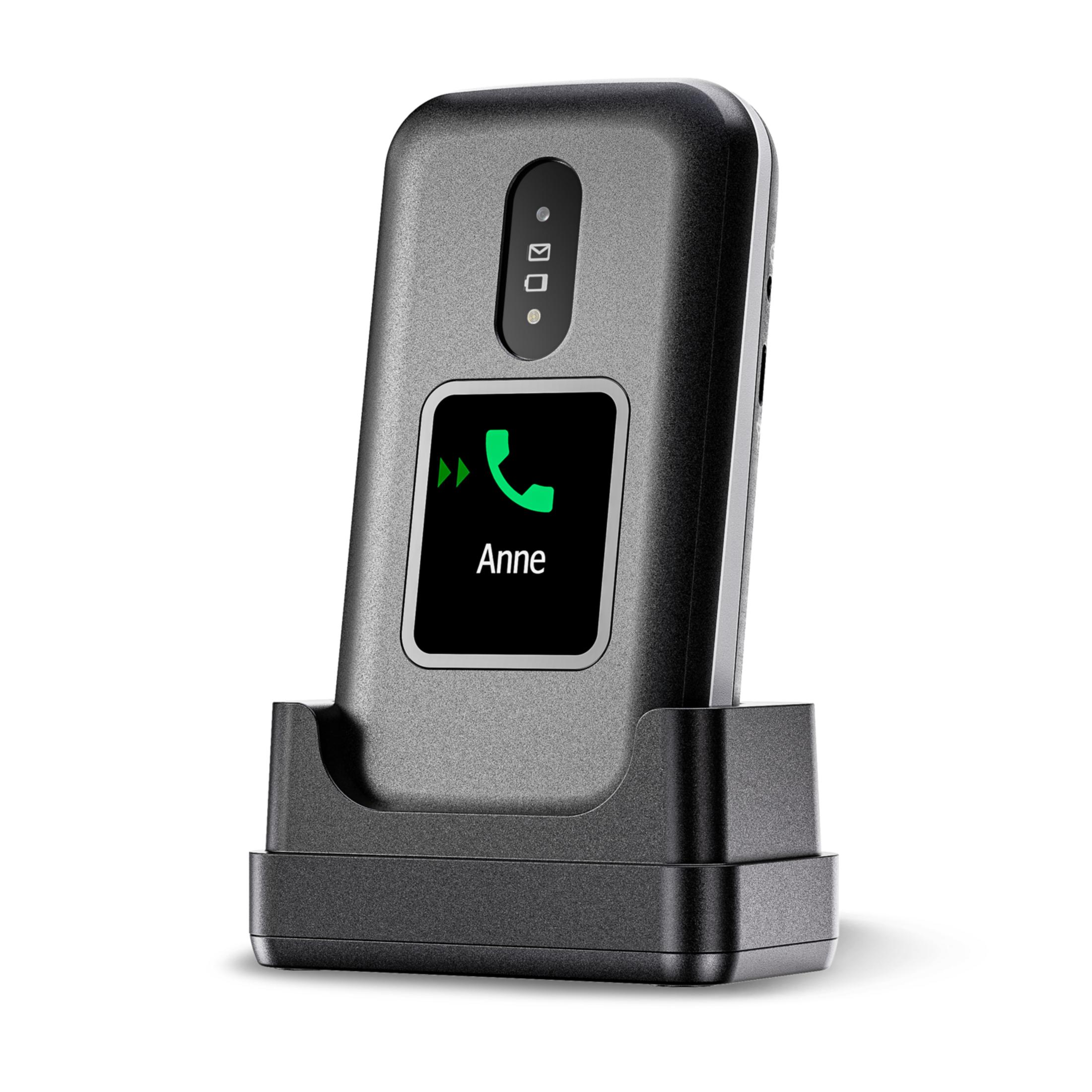 Un teléfono inalámbrico gris con un icono de llamada verde y el nombre Anne en pantalla.