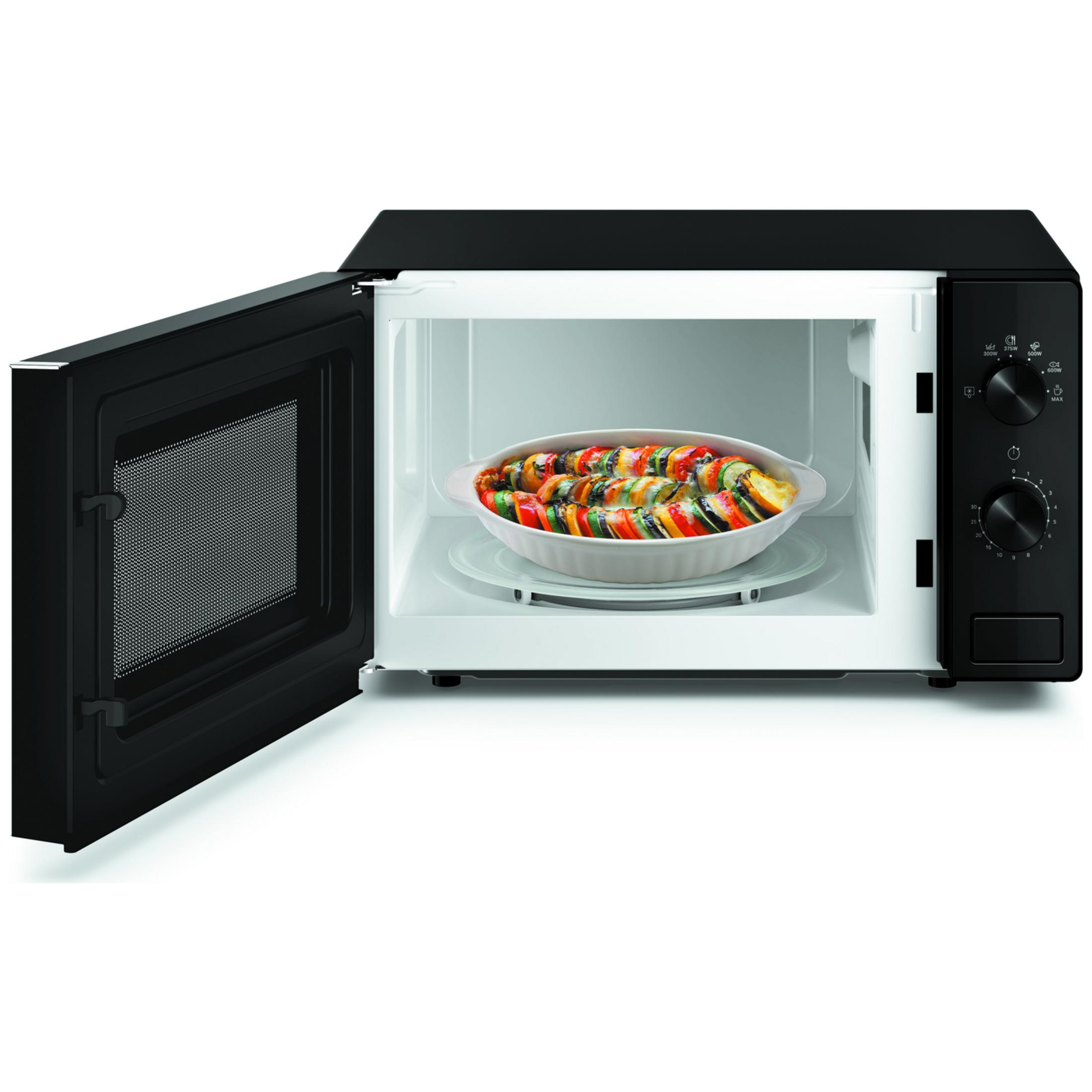 Een open magnetron met een ovenschotel met gelaagde groenten erin.