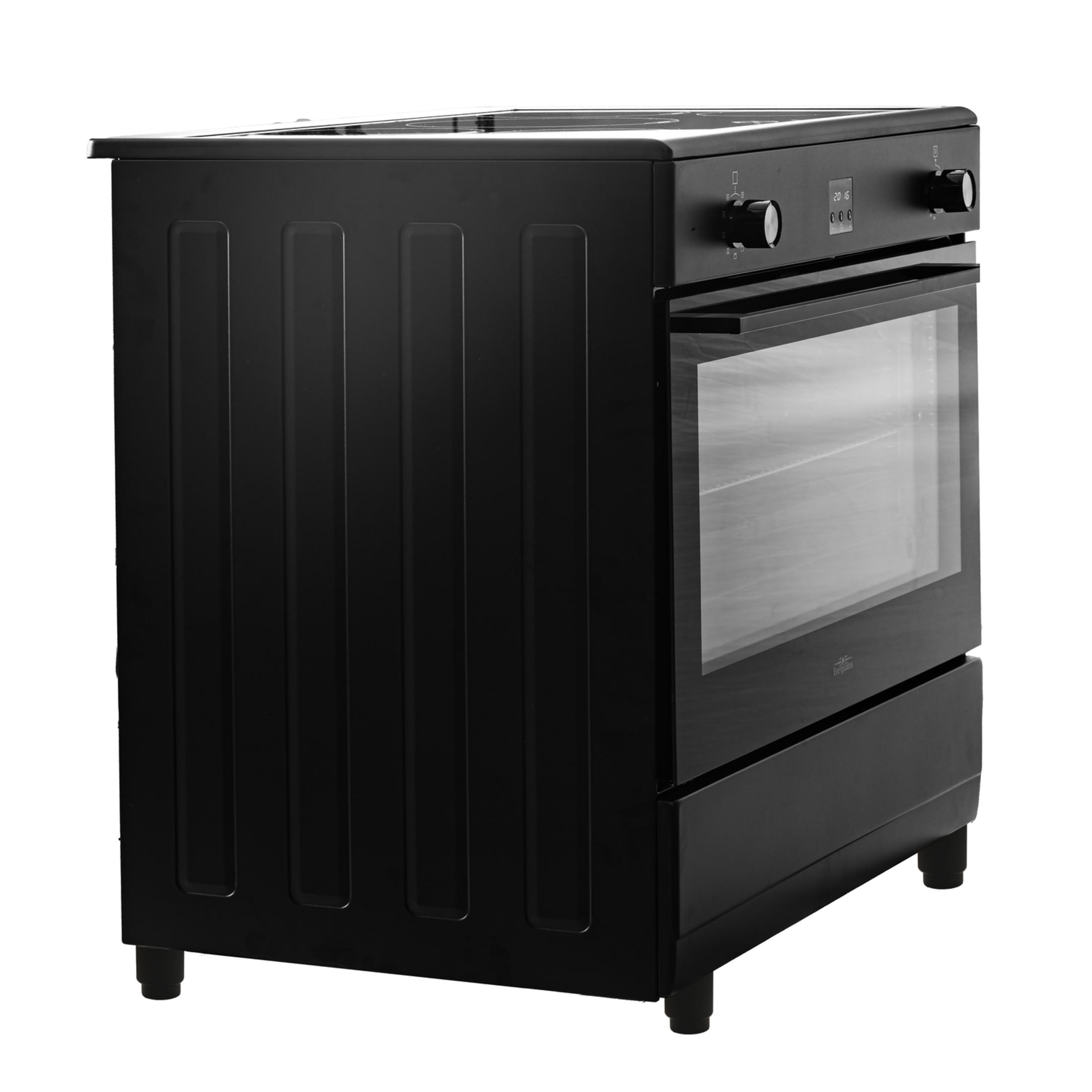 Black oven with glass door and digital display, white back panel.