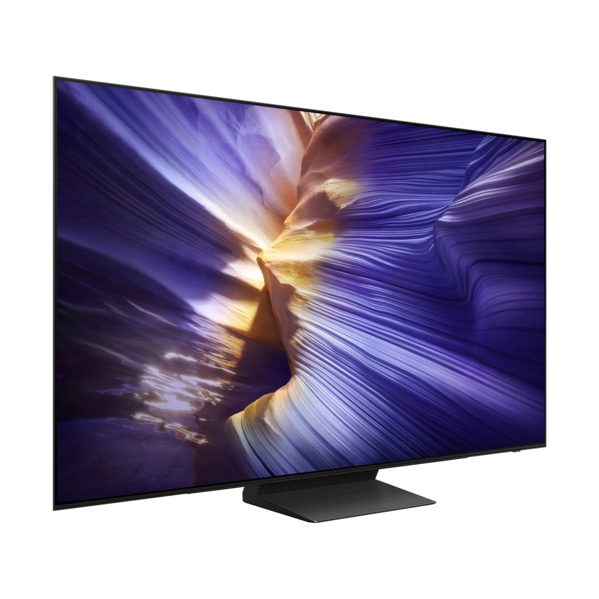 Un televisor moderno y elegante muestra una vibrante imagen abstracta de formaciones rocosas moradas y amarillas.