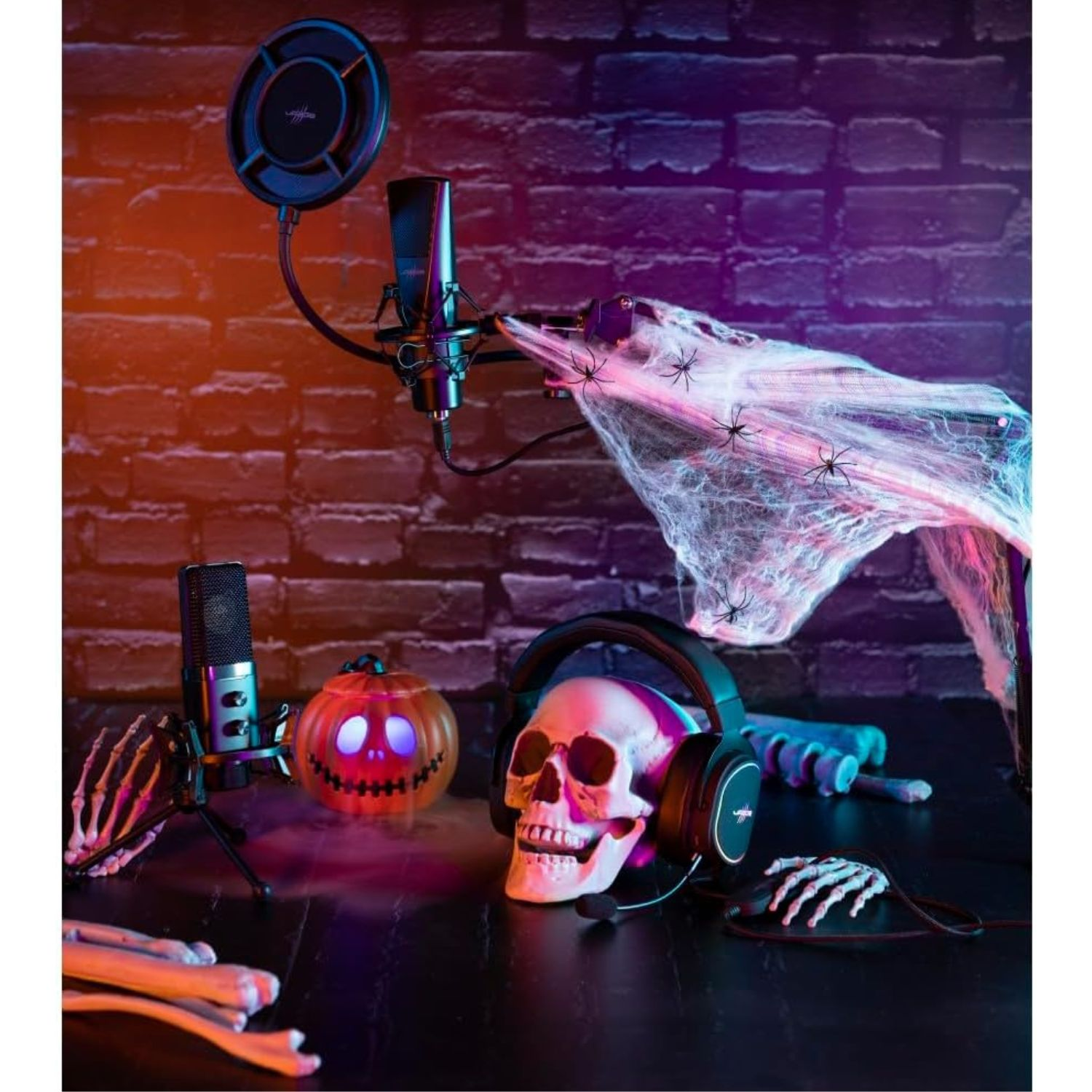 Ein Totenkopf mit Kopfhörern, eine Kürbislaterne und Spinnennetze auf einem Tisch.
