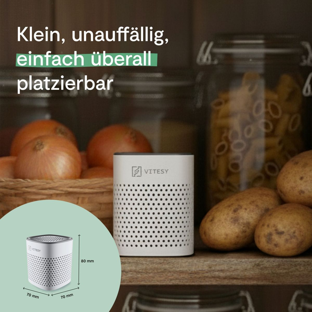 Ein kleiner weißer VITESY Lautsprecher steht neben Kartoffeln und Zwiebeln.
