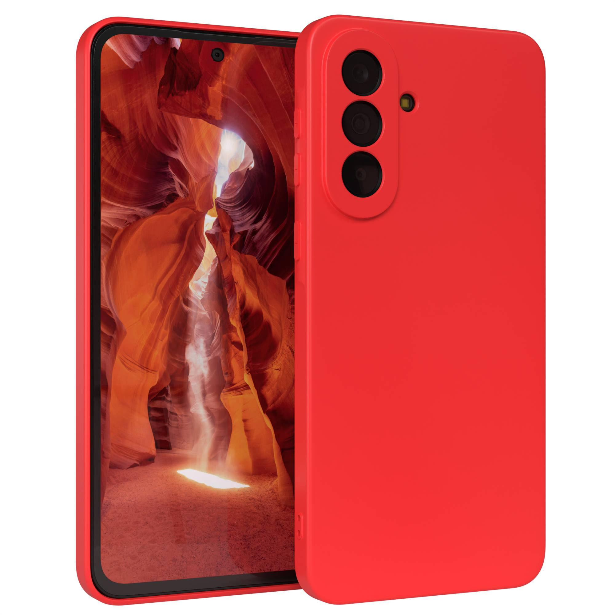 Rotes Smartphone mit drei Kameras, das auf einem Hintergrund mit einer Canyon-Landschaft steht.