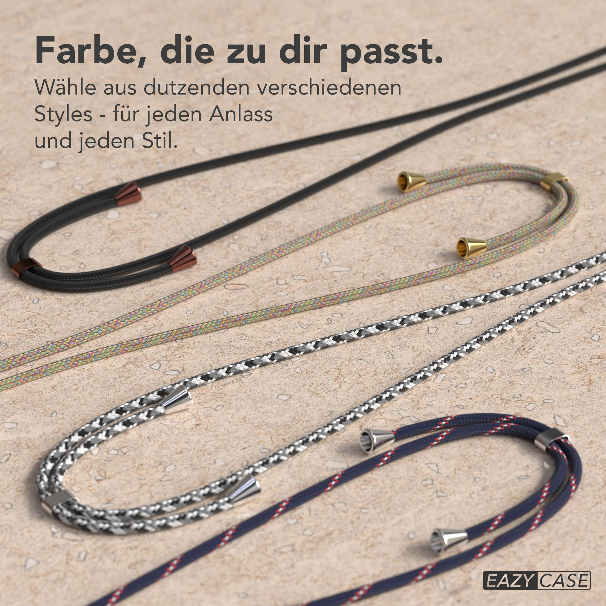 Drei bunte Kordeln mit Metall-Enden liegen auf einem Steinboden.