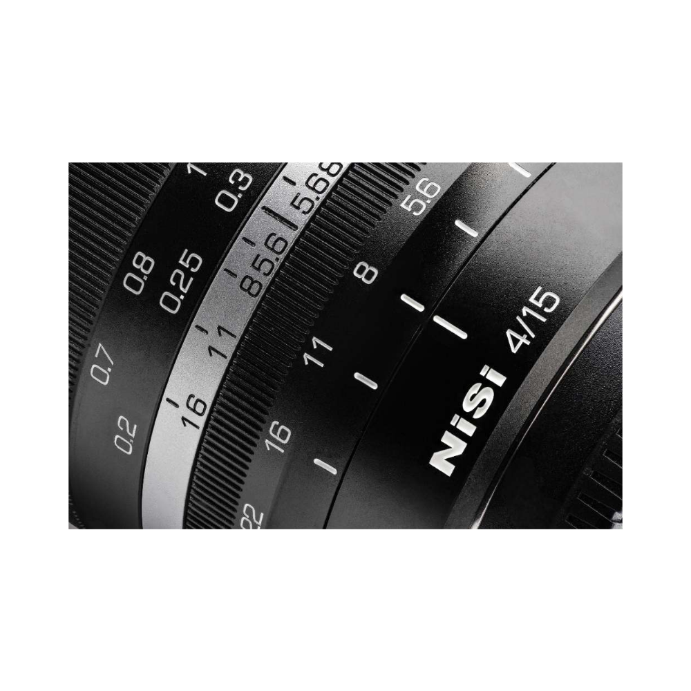 Close-up of a camera lens scale with focus and aperture markings.