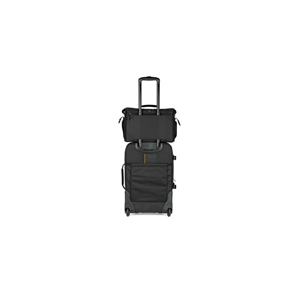 A black rolling suitcase topped with a black carry-on bag, with its handle extended.