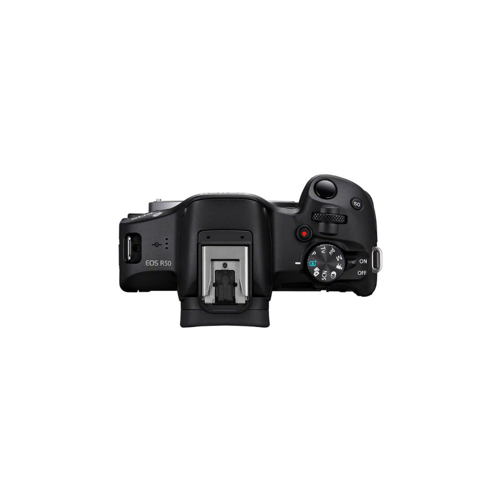 A black Canon EOS R50 camera from above, showing the hot shoe and control dials.