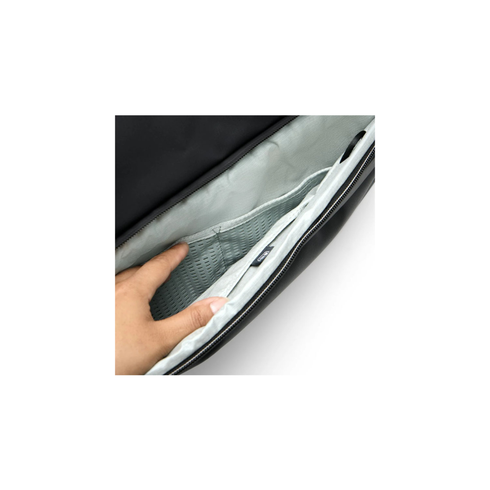 A hand reaches into an open black bag with a grey interior lining.