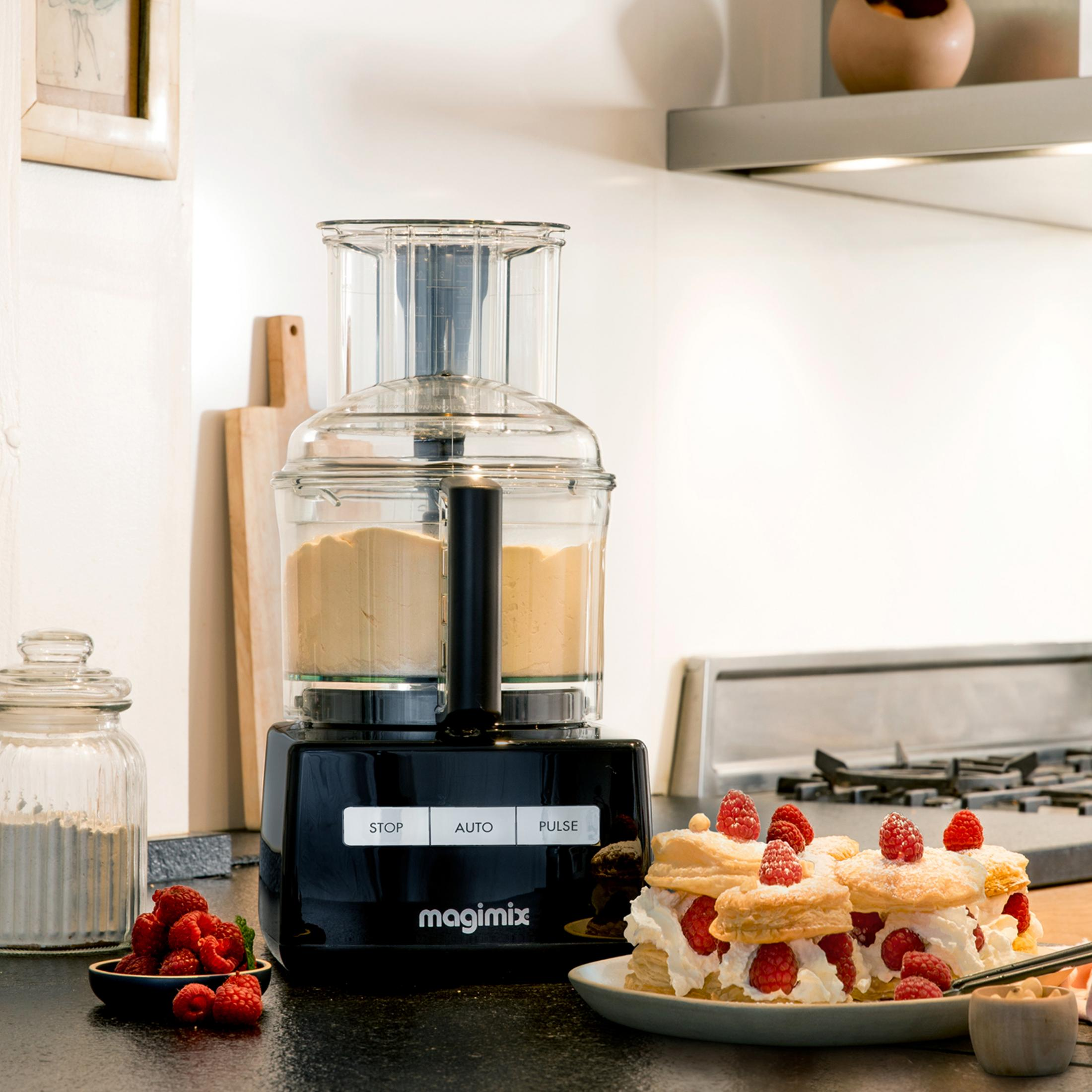 A black Magimix food processor with dough and raspberry desserts beside it.