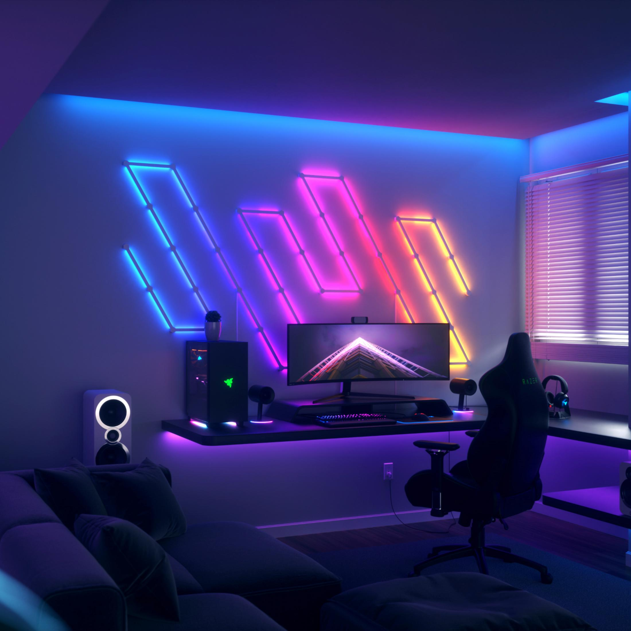 Una stanza da gaming con luci al neon, scrivania, sedia, computer e divano.