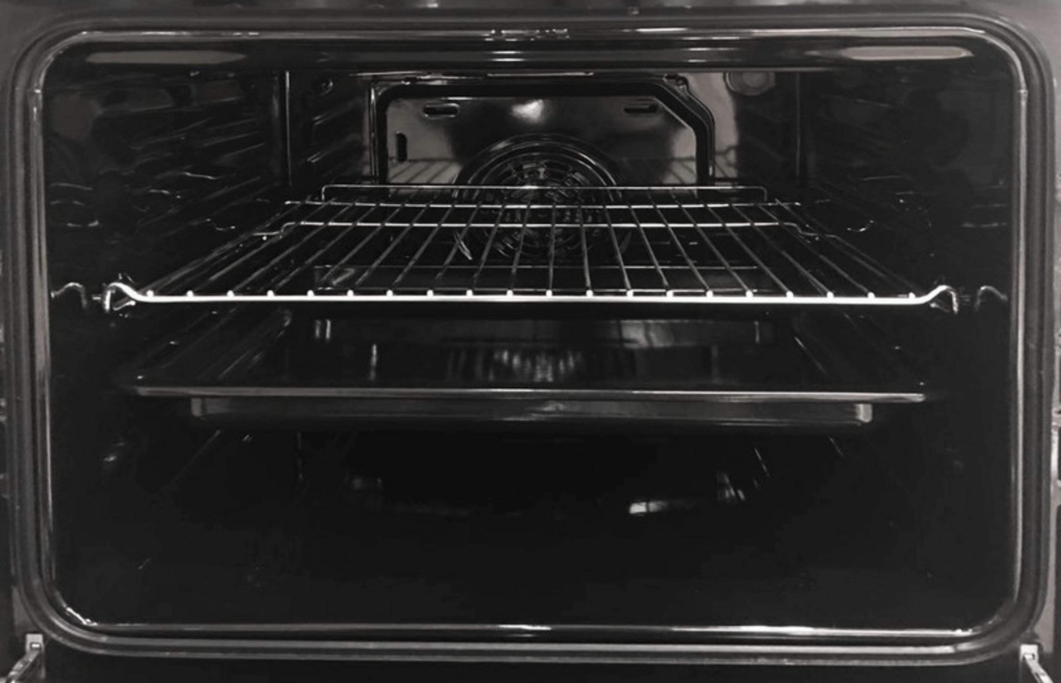 An empty oven interior with a rack and a baking tray.