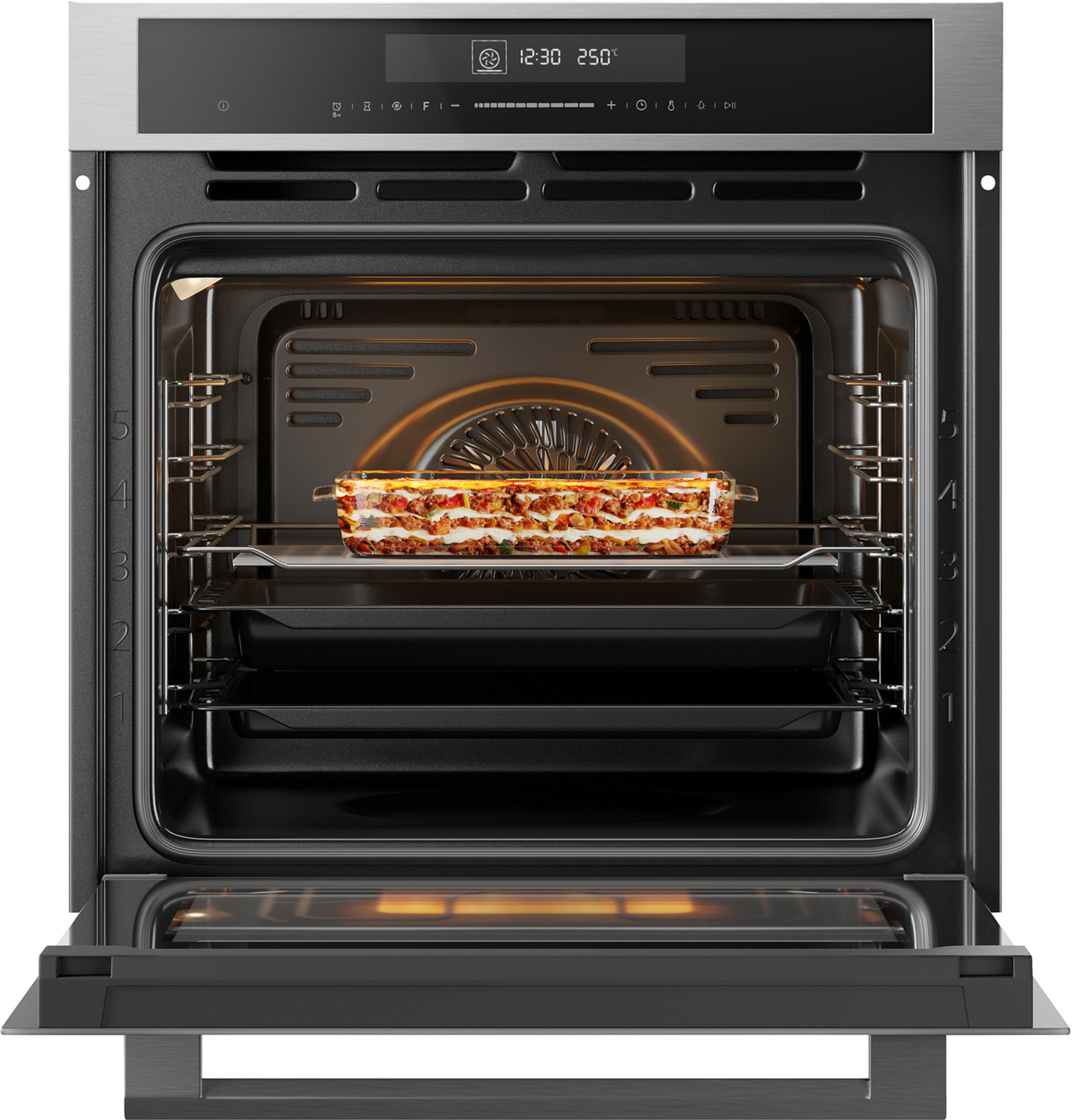 An open oven with a lasagna on a rack. The interior light is on.
