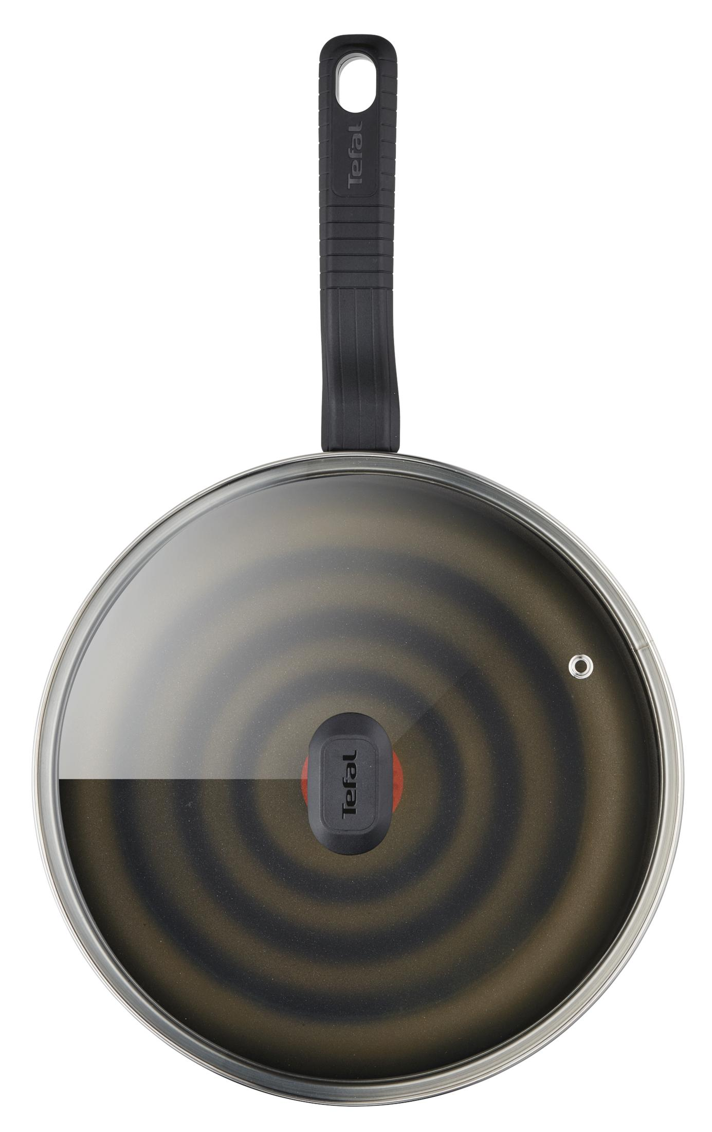 Eine Tefal-Pfanne mit Glasdeckel und schwarzem Griff, mit konzentrischen Ringen auf der Oberfläche.
