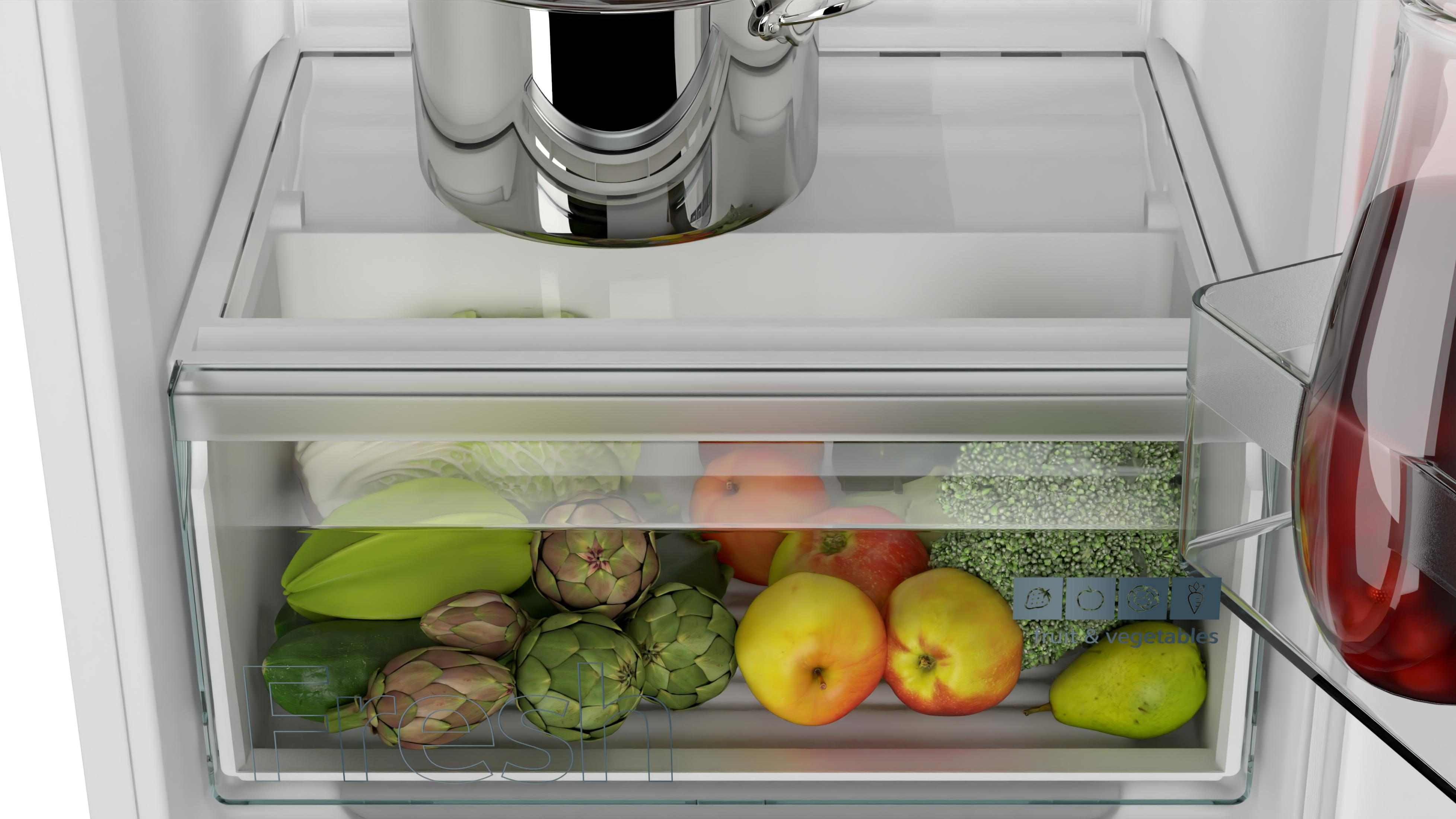 Refrigerator drawer with fruits and vegetables: apples, pears, broccoli, artichokes.