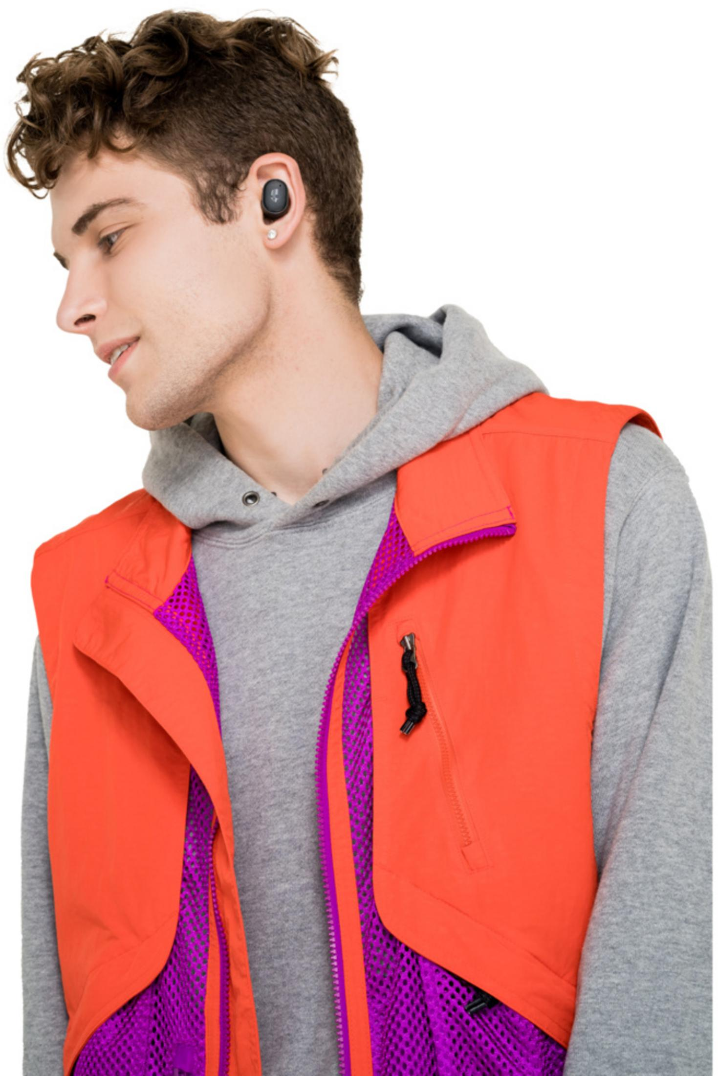 Young man wearing earbuds, orange vest over grey hoodie.