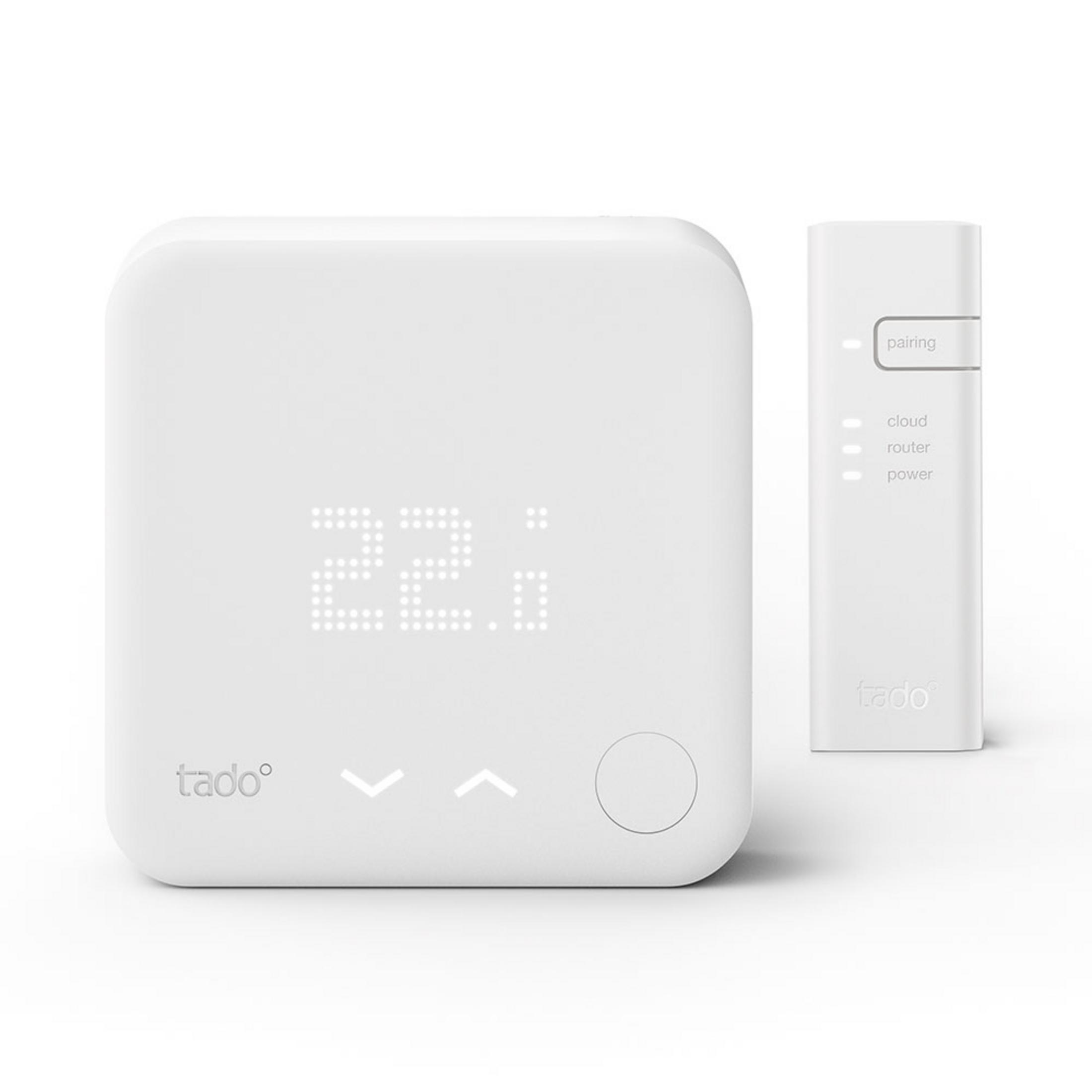 Two white Tado devices: a thermostat with a display and a pairing module.