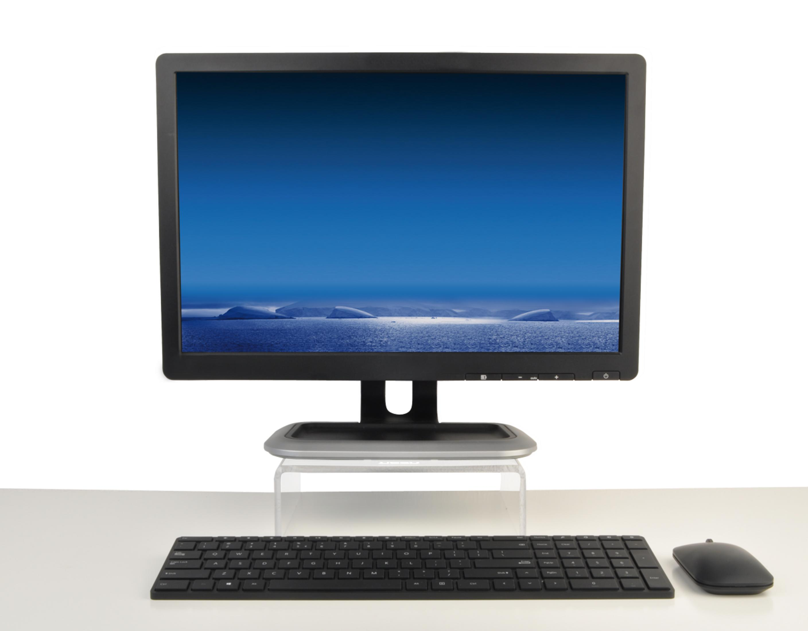 Schwarzer Monitor mit Eisberg-Hintergrund, Tastatur und Maus auf weißem Tisch.