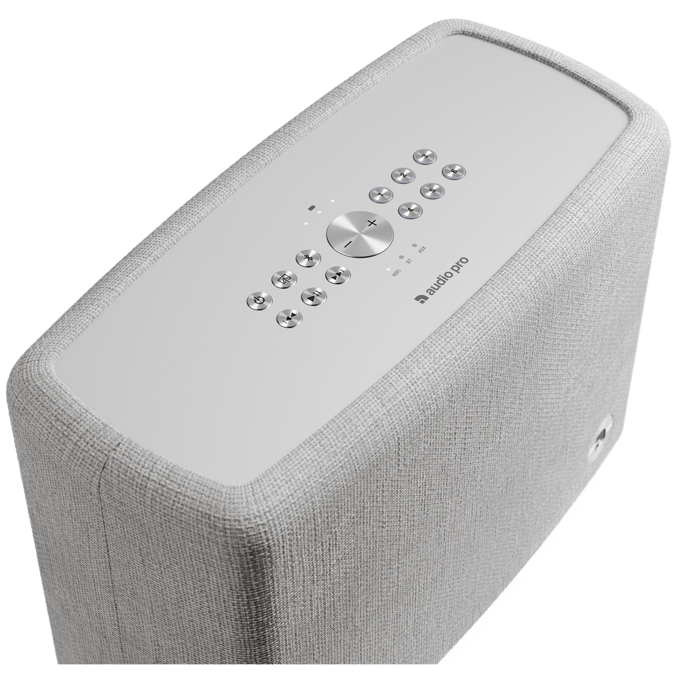 Un haut-parleur blanc avec des boutons de commande et le logo Audio Pro sur le dessus.