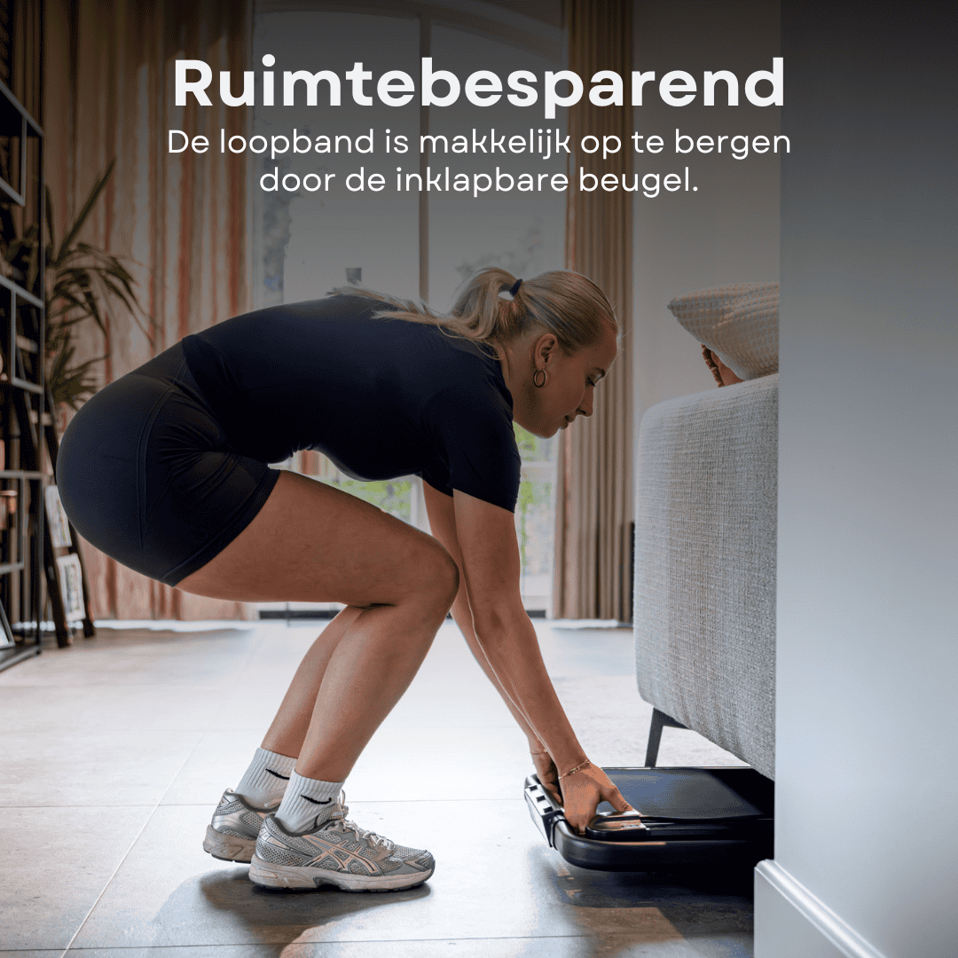 A woman stores a black treadmill under a sofa.