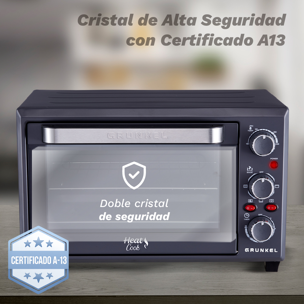 Horno de sobremesa gris oscuro con asa y mandos plateados. Puerta de cristal con certificado seguridad.