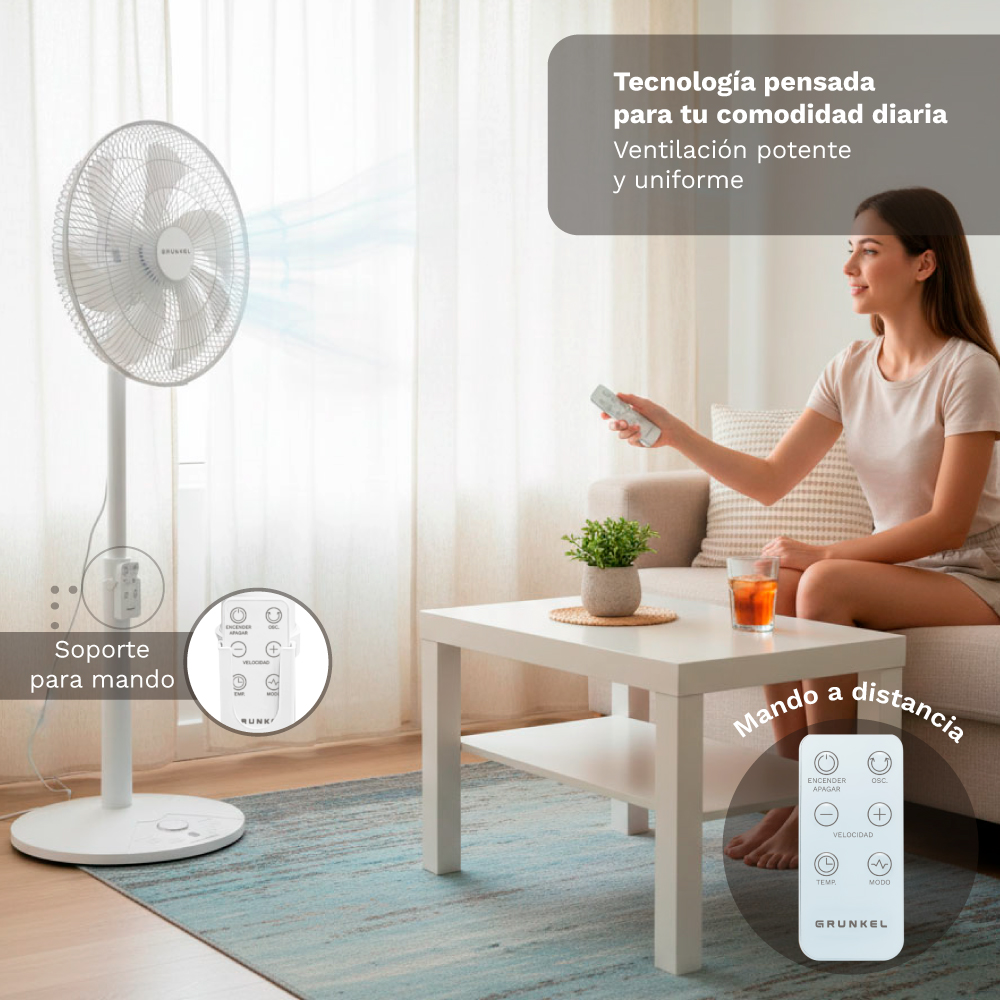 Un ventilador de pie blanco con mando a distancia y una mujer sentada.
