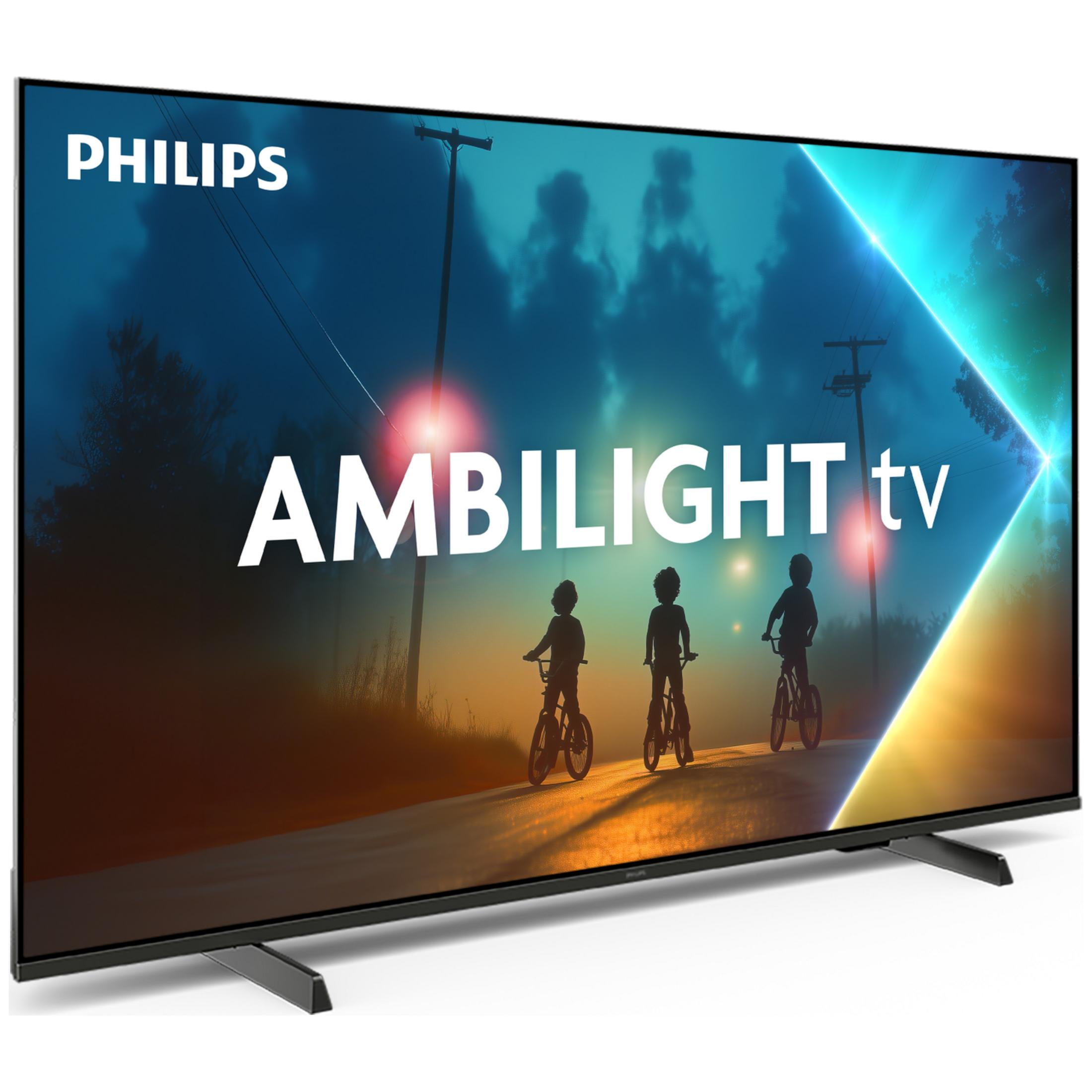 Telewizor Philips Ambilight pokazuje sylwetki dzieci na rowerach o zachodzie słońca.