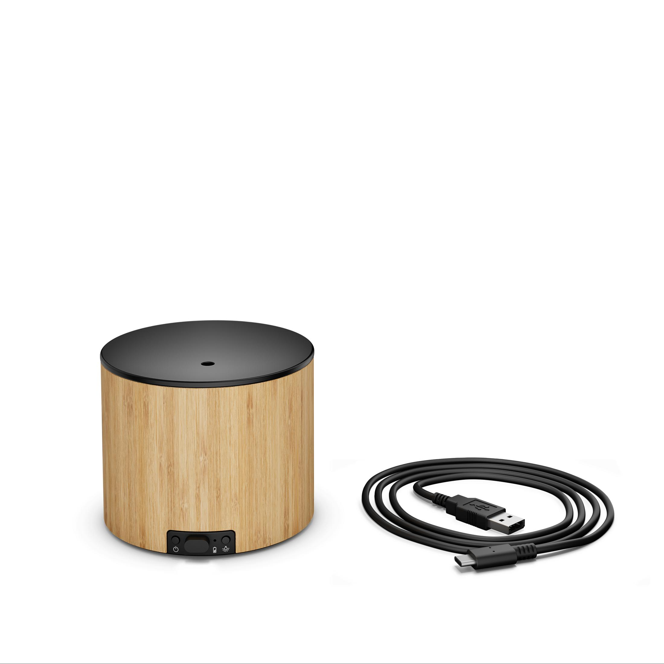 A cylindrical bamboo diffuser with a black top and a USB cable.