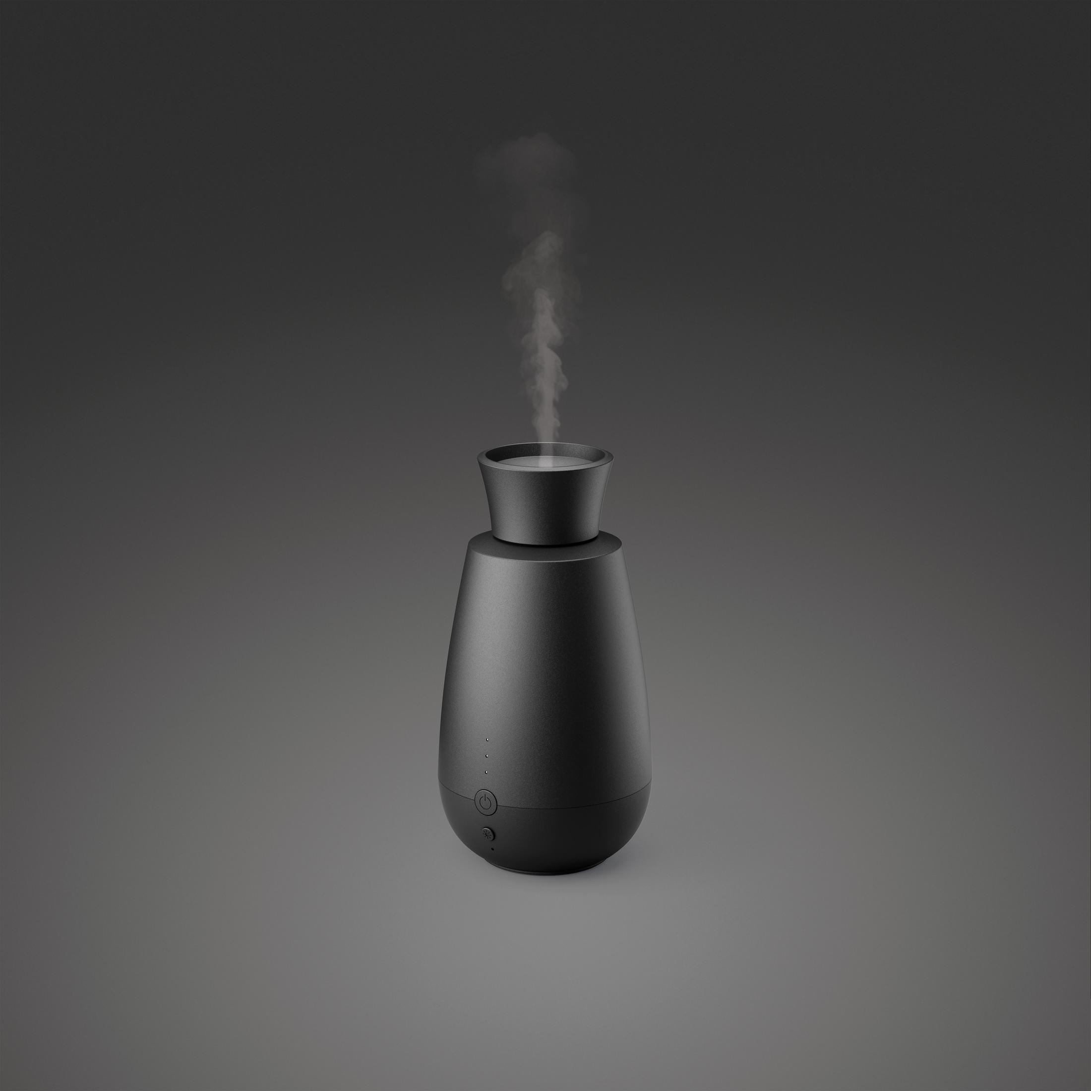 A black diffuser emits steam. It has buttons and lights.
