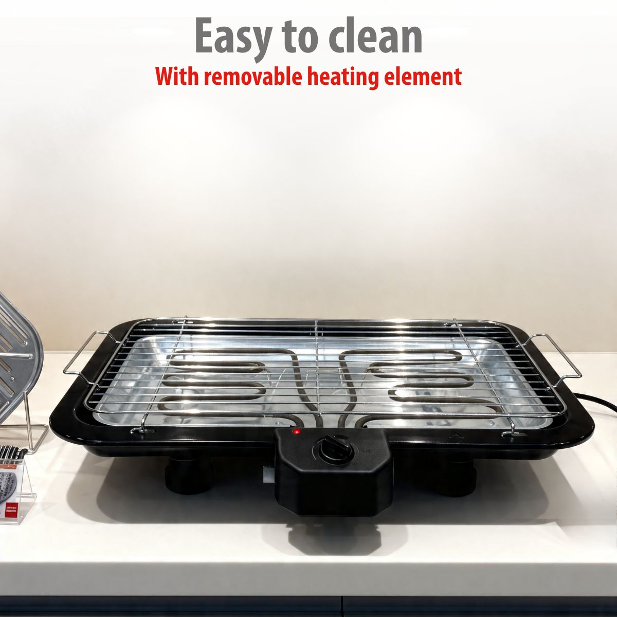 Electric tabletop grill with black casing, chrome grate, and heating coils.
