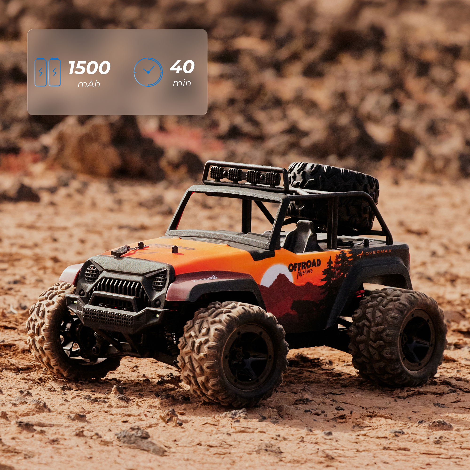 Ein orangefarbener RC-Geländewagen mit großen Reifen und Ersatzrad auf felsigem Boden.