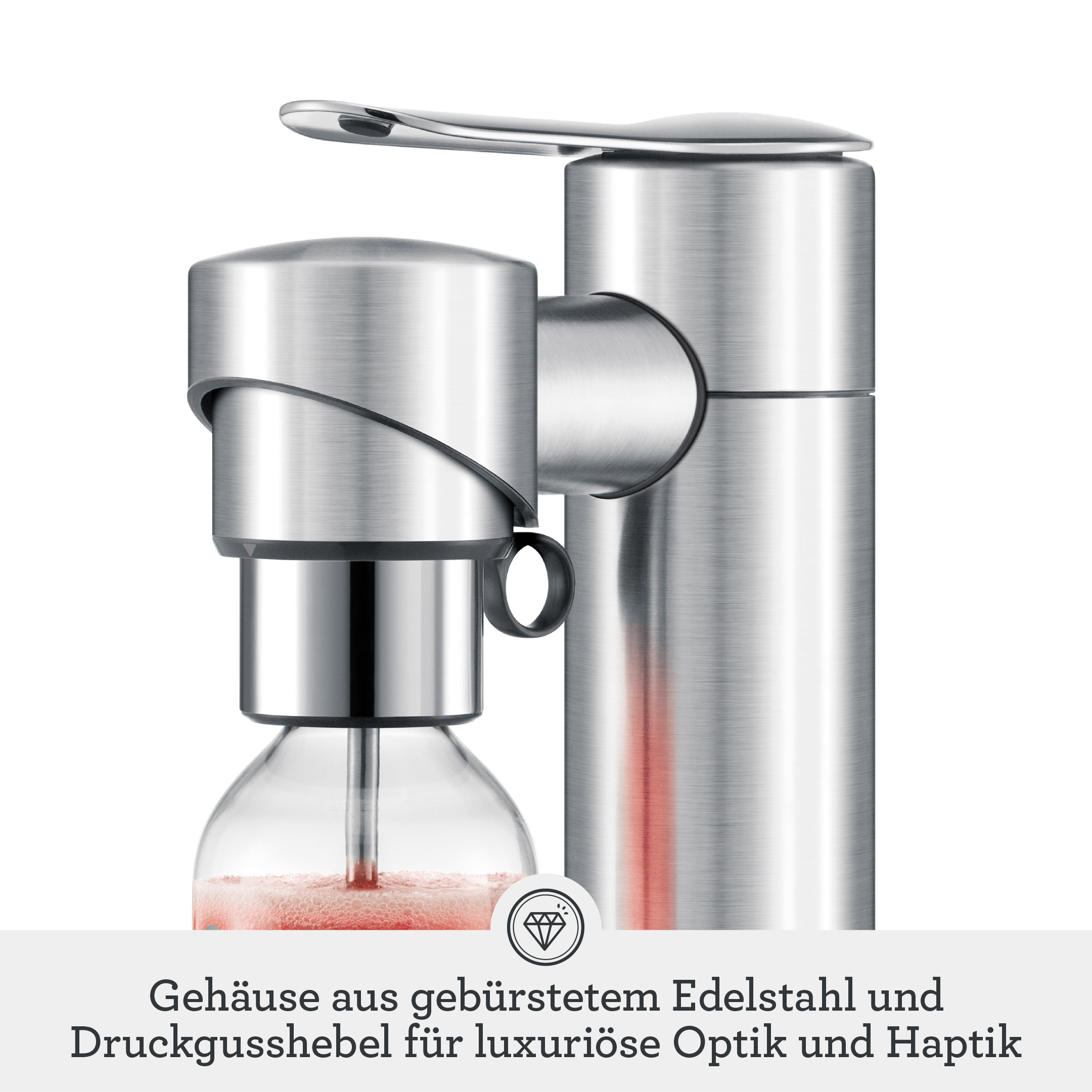 Ein silberner Seifenspender mit Glasflasche, gefüllt mit rosafarbener Flüssigkeit.