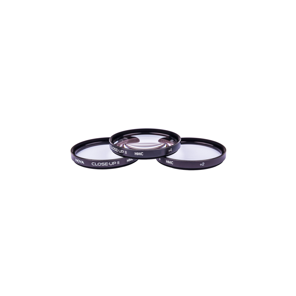 Three Hoya close-up lenses with black rims are on a white background.