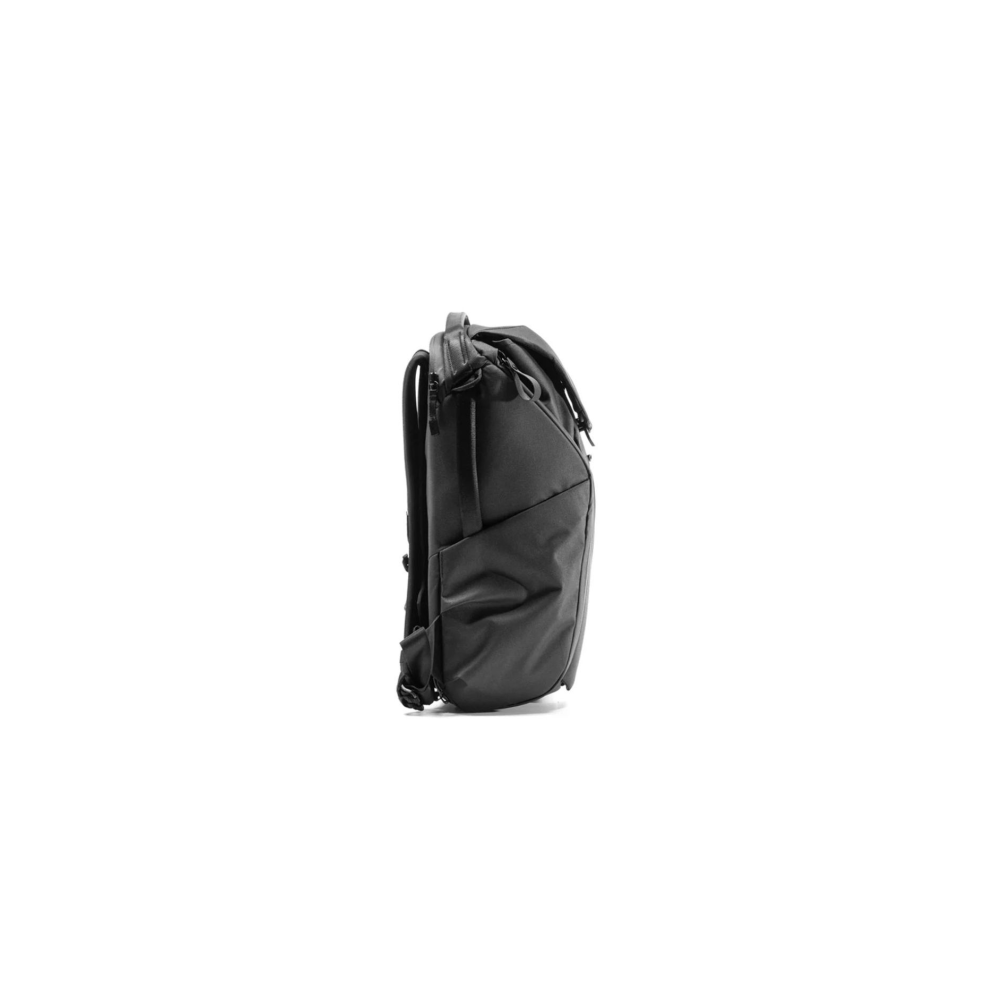 A black backpack with straps and zippers, seen from the side.