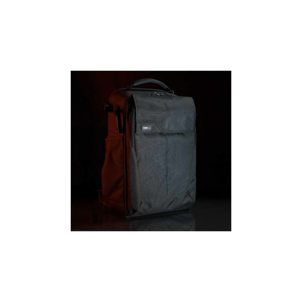 Black camera bag with handle and zipper, displayed on a dark background.