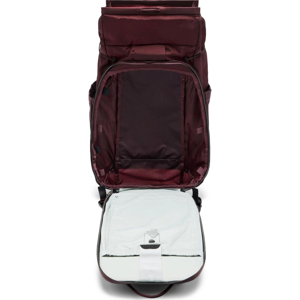 A dark red backpack with its main compartment open, revealing a white interior.