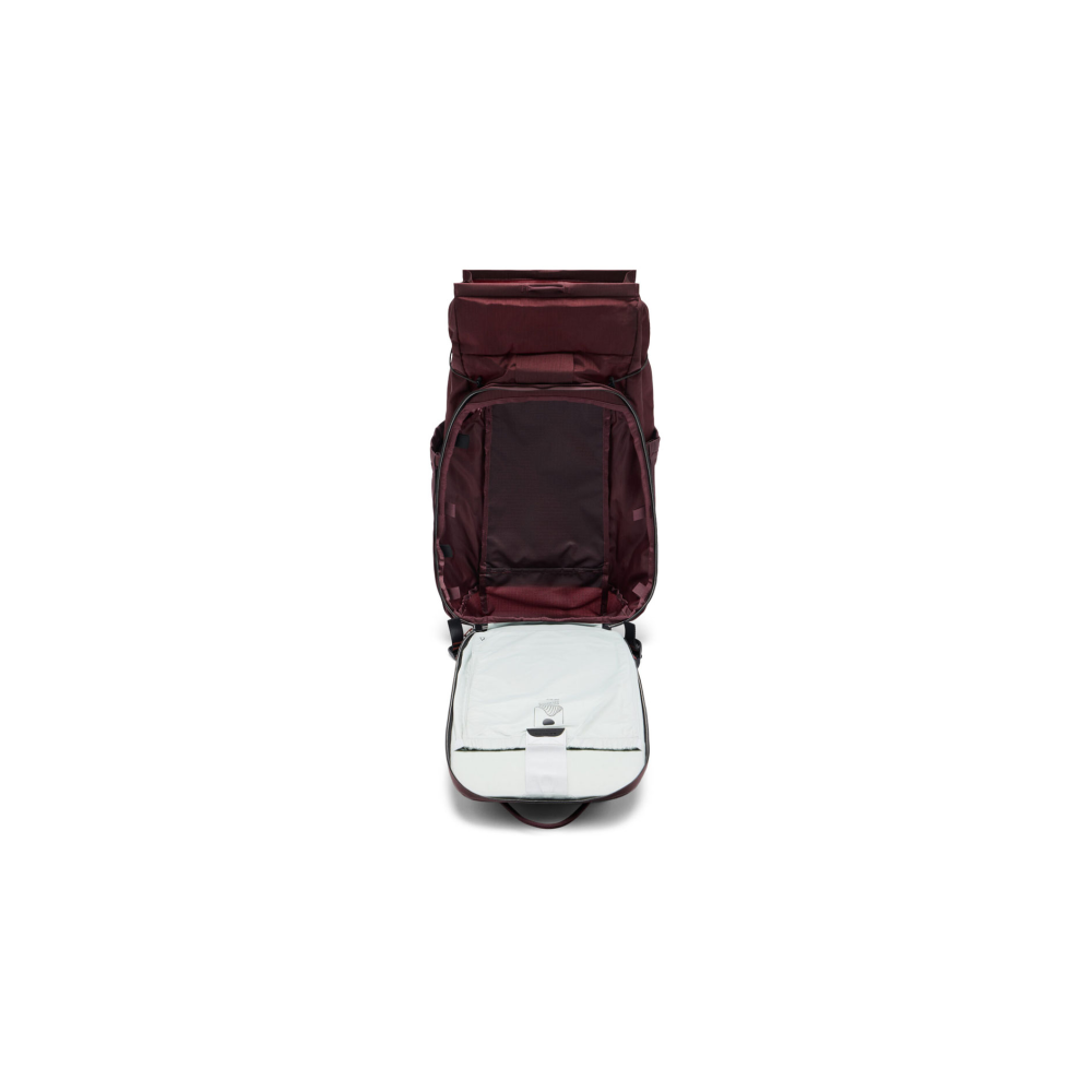 A dark red backpack is open, showing its interior compartment.