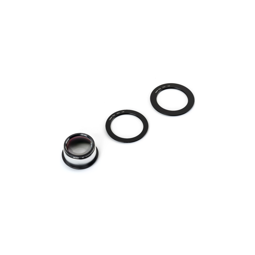 A lens and two black adapter rings lie on a white background.