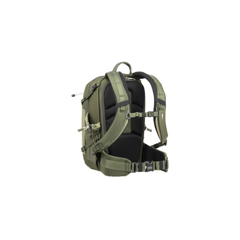 Green backpack with padded straps and hip belt, viewed from the back.