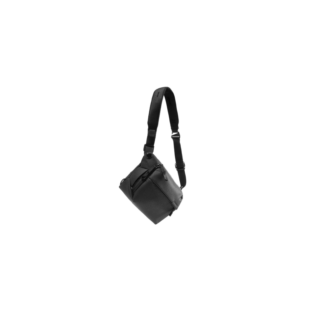 Een zwarte crossbody tas met één riem hangt tegen een witte achtergrond.