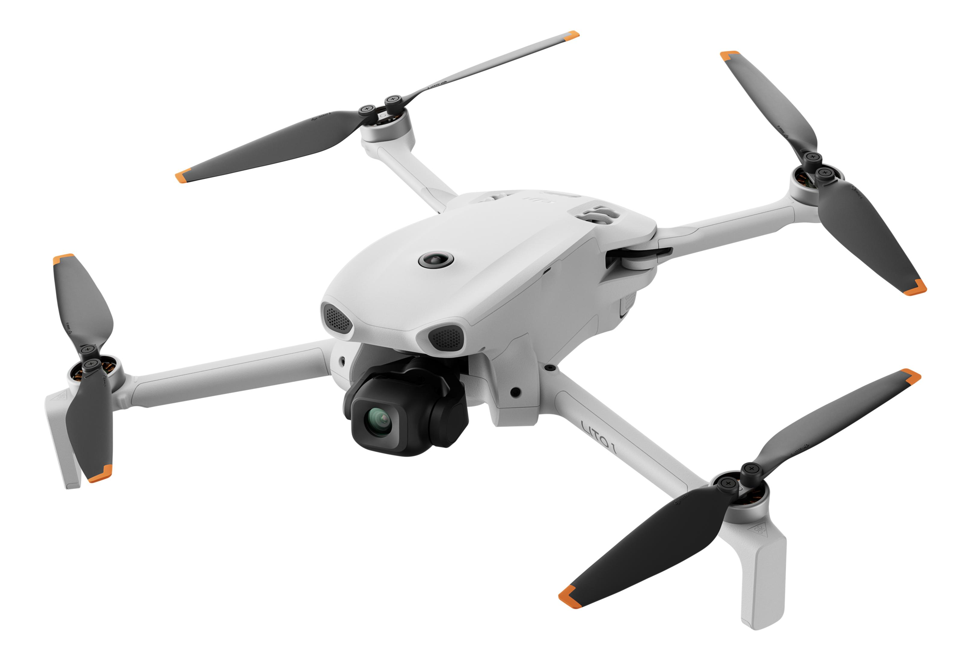 Un dron blanco con cuatro hélices y cámara, flotando.