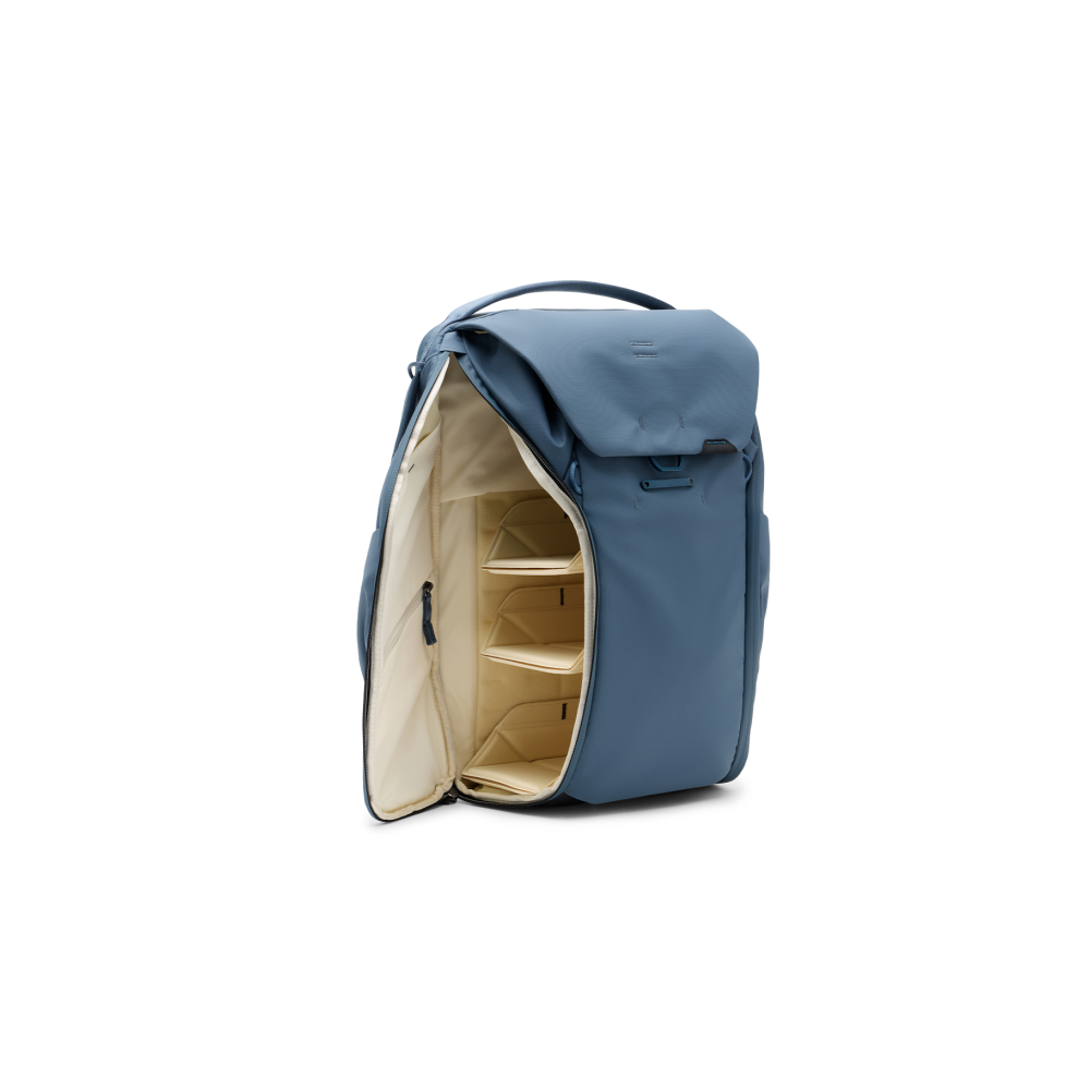 A blue backpack with its compartment open, showing three dividers.