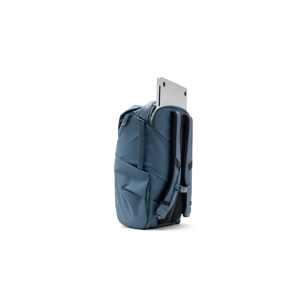 A blue backpack with a laptop sticking out of the top.