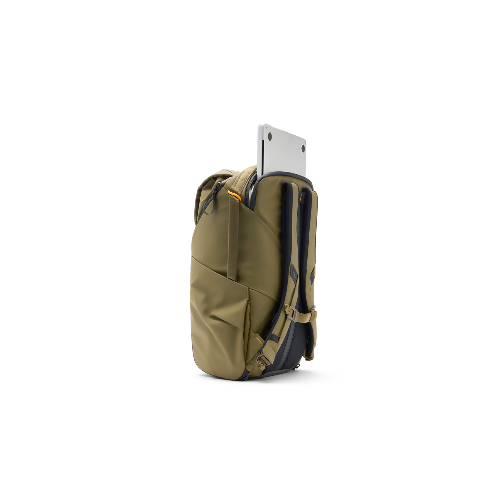 An olive green backpack with a laptop peeking out of the top compartment.